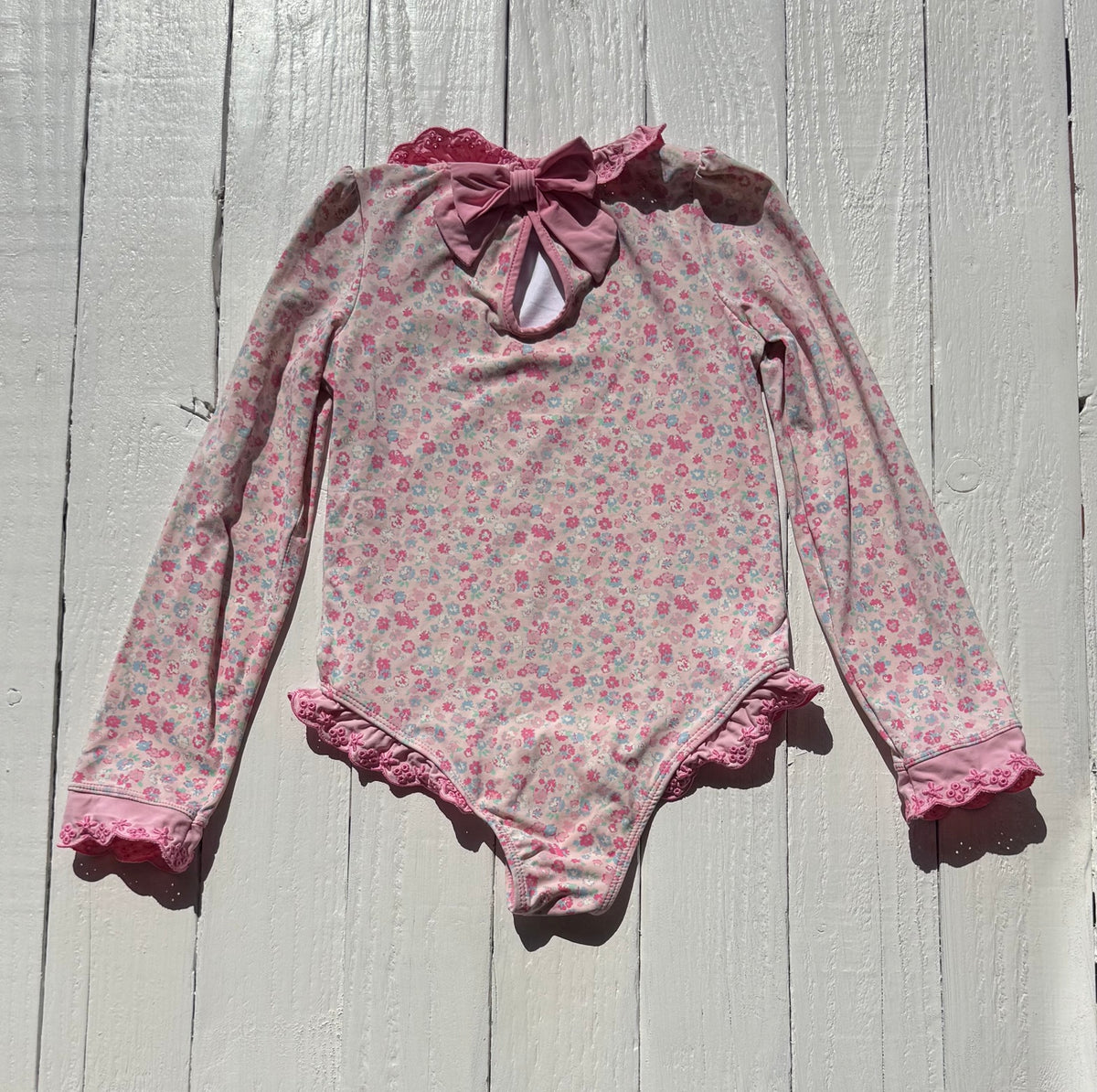Back of The Beaufort Bonnet Company floral swimsuit with pink bow
